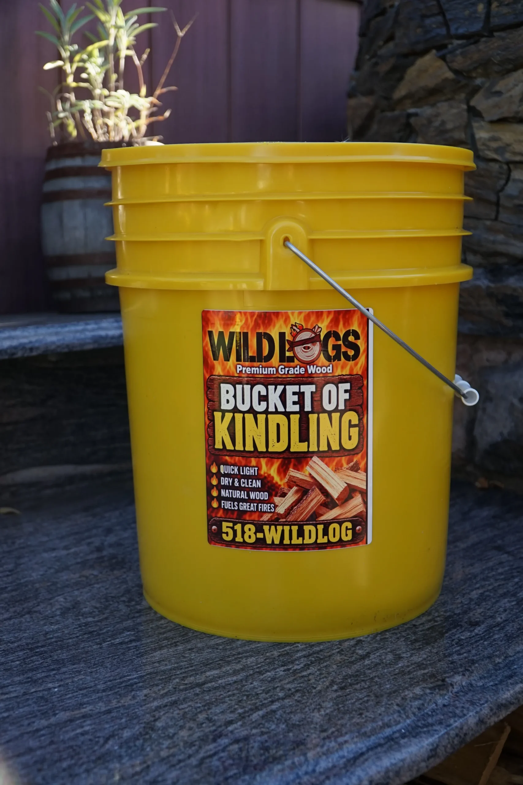 Yellow bucket with a label that says: Wildlogs Premium Grade Wood Bucket of Kindling