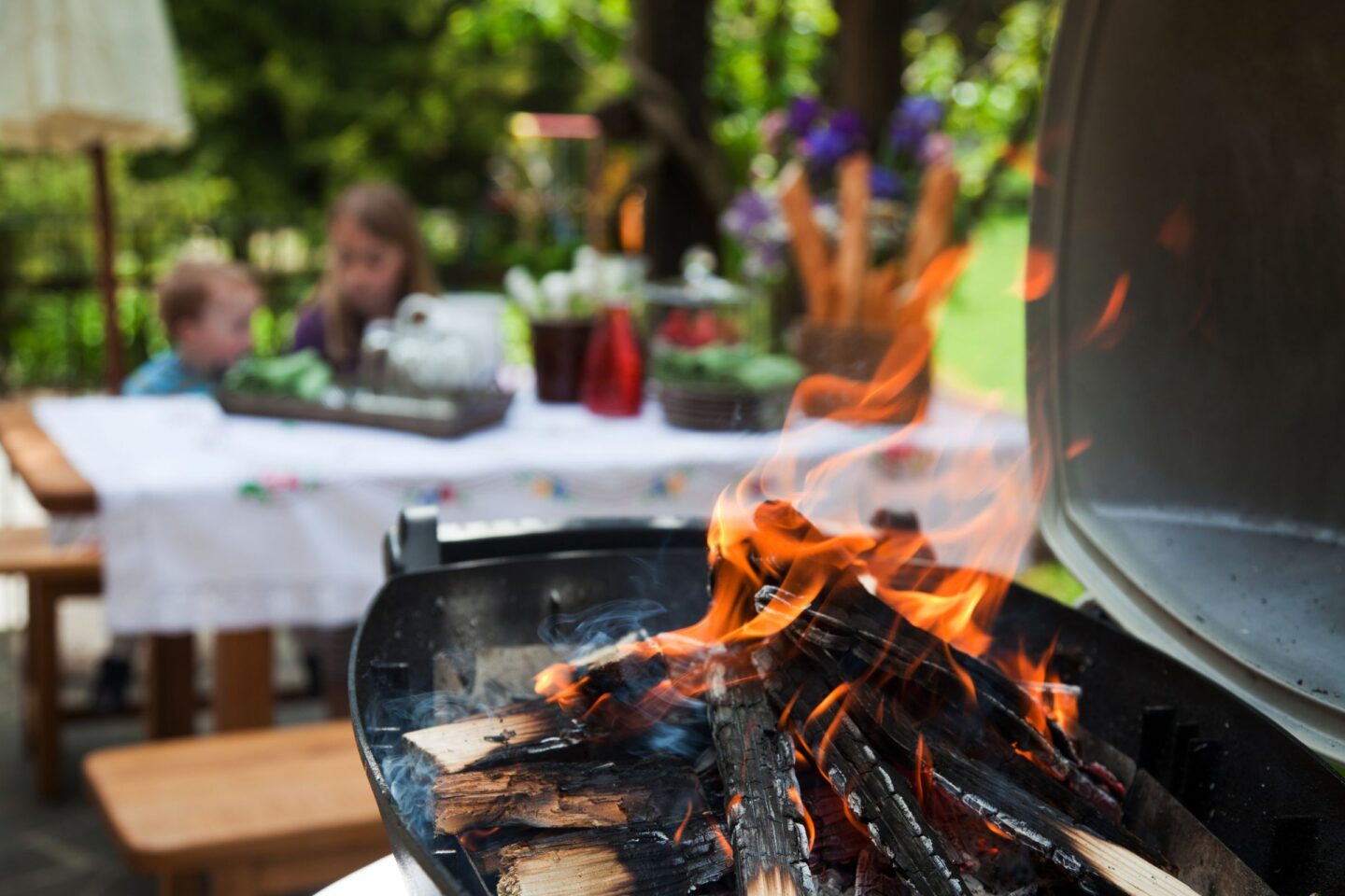 firewood burning in a grill at a BBQ